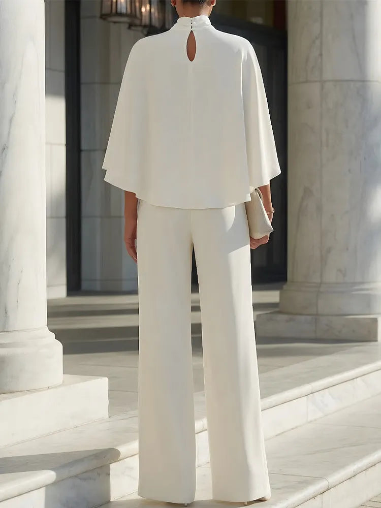 Blouse with cape sleeves and high neckline & wide trousers with slit