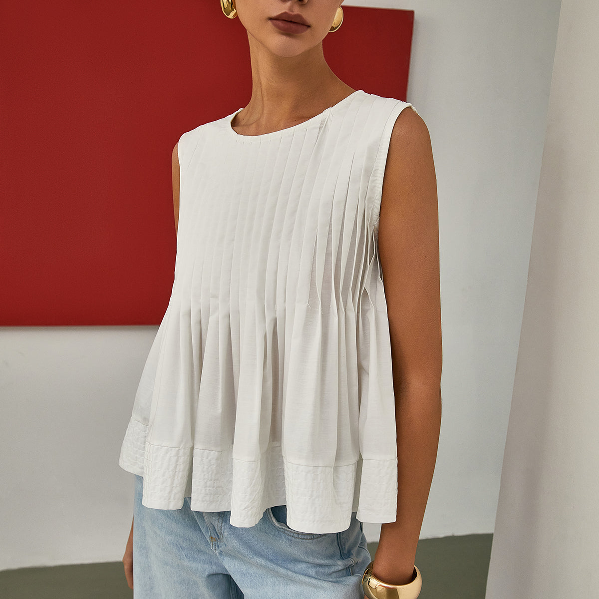 Celia | Bluzka bez rękawów z plisowanym peplum