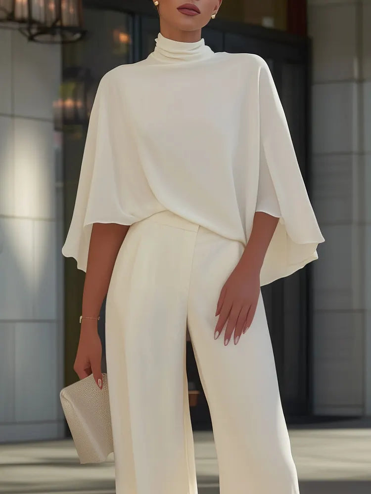 Blouse with cape sleeves and high neckline & wide trousers with slit